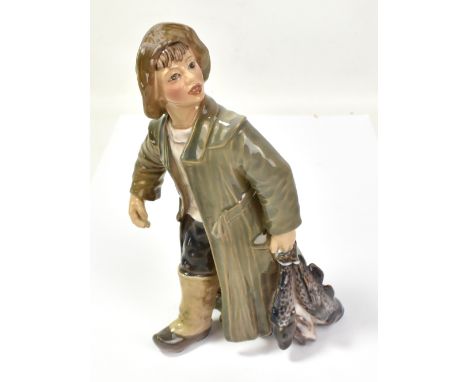 DAHL JENSEN FOR COPENHAGEN; a ceramic figure modelled as a fisher boy carrying his catch, with printed mark and no. 1294 to b