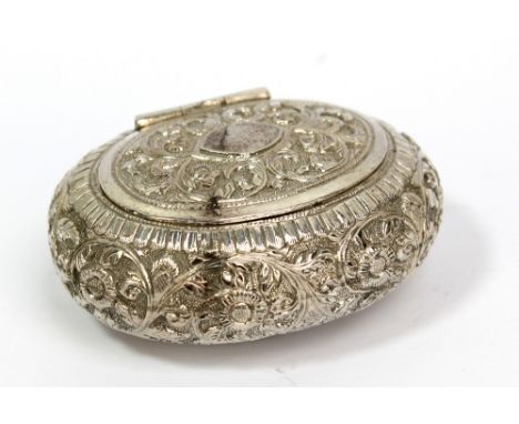A white metal oval snuff box with chased foliate scroll decoration and vacant cartouche to hinged lid, unmarked, width 7cm.