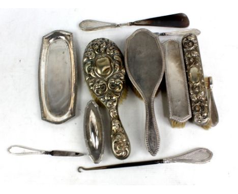 HENRY MATTHEWS; a George V hallmarked silver nine piece dressing table set with overall engine turned decoration and floral b