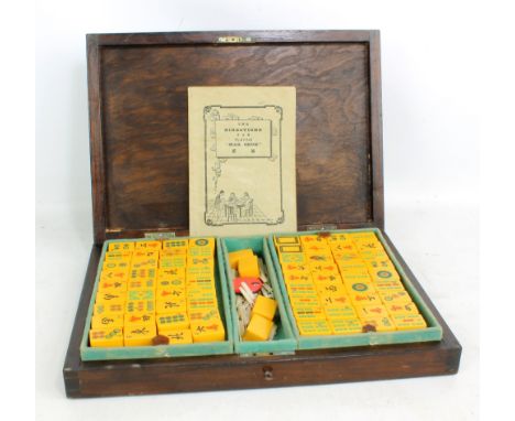 A stained beech cased Mahjong set with amber coloured tiles (including four spares), and various other accessories including 