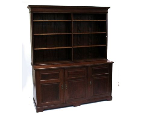 A large early 20th century mahogany bookcase, the top with moulded cornice above two formations of four adjustable open shelv