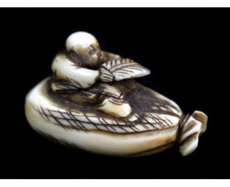 An early 20th century Japanese carved ivory netsuke of a figure seated upon a sack, indistinctly signed, length 4cm.Additiona