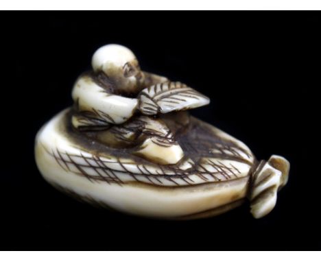 An early 20th century Japanese carved ivory netsuke of a figure seated upon a sack, indistinctly signed, length 4cm.Additiona