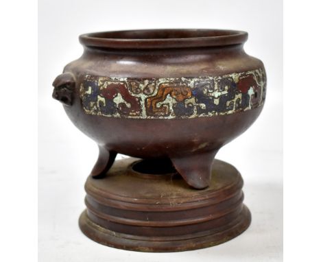 A Chinese bronze and champlevé enamel decorated censer on integral circular base, height 13.5cm.Additional InformationHeavily