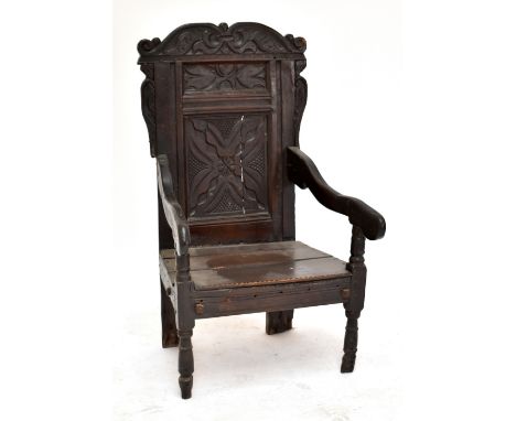 A 17th century and later oak Wainscot chair with carved splat and raised on ring turned front supports.