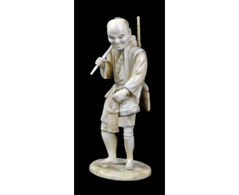 A Japanese Meiji period Tokyo School ivory okimono depicting a gentleman carrying baskets and broom, inset red 'tablet' and r