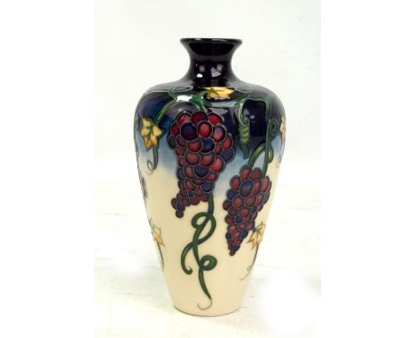 MOORCROFT; a navy and cream ground grape and vine tubeline decorated vase, impressed marks and year cipher for 2009 to base, 