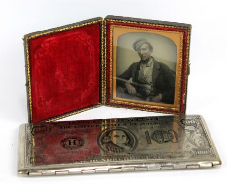 An unusual novelty cigarette case modelled as an American hundred dollar bill, length 17cm, also a Daguerreotype of a young g