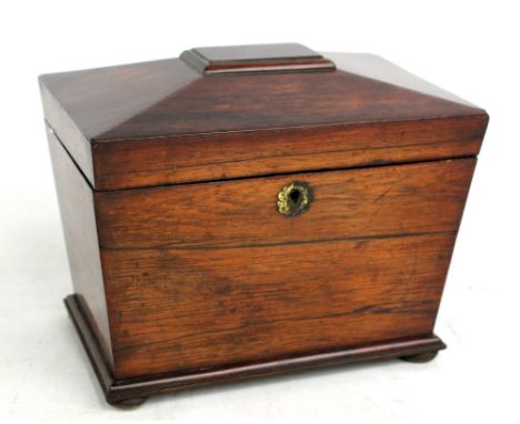 A Regency rosewood sarcophagus tea caddy, the hinged lid enclosing two sectioned lidded interior, on turned bun feet, width 2