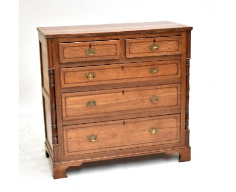 An early Victorian North Country oak and mahogany chest of two short over three long drawers, flanked by half spindles and ra
