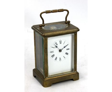 A French brass carriage clock, the square dial set with circular chapter ring with Roman numerals, stamped 0933 to the frame 