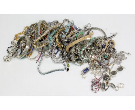 A large collection of silver and base metal bracelets, tennis bracelets, bangle, etc.&nbsp;