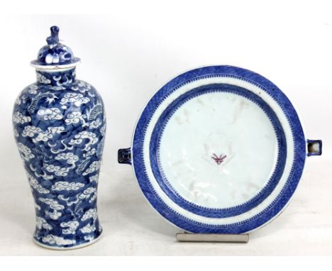 A late 19th century Chinese blue and white painted baluster vase and cover, the body decorated with two four clawed dragons c