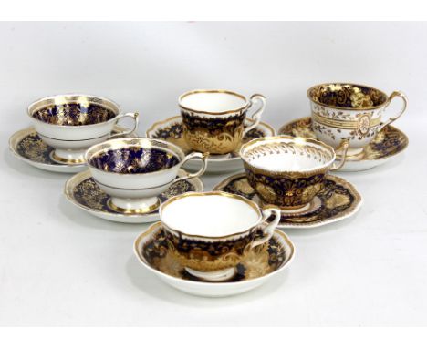 COALPORT; four 19th century blue and gilt cups and saucers, one with hand painted floral decoration, and a pair of early 20th