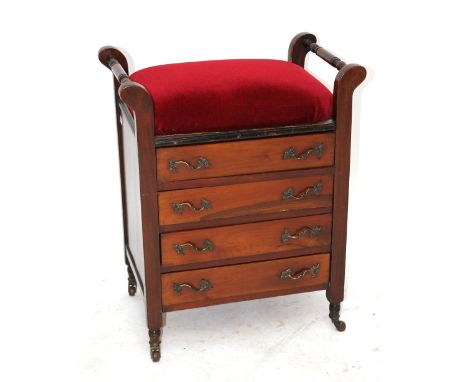 An Edwardian walnut piano stool with four drawers above ring turned supports to castors.