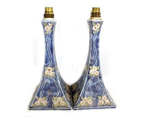 ROYAL DOULTON; a pair of Doulton Lambeth Art Nouveau tapering square sectioned lamp bases, each with tubeline stylised floral