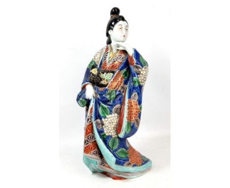A large Japanese Kutani figure of a geisha with a gilt and enamel robe, decorated with a dragon, flowers and leaves, unmarked
