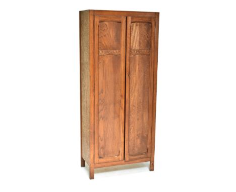 An oak hall robe, the twin doors with carved detail enclosing single shelf and arrangement of hooks, 182 x 78.5cm.