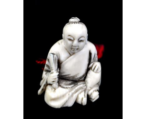 A Japanese Meiji period ivory netsuke of a seated gentleman holding fan, signed in red to base, height 3.6cm.Additional Infor