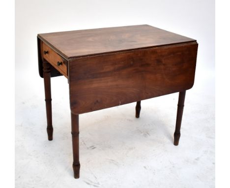 A Victorian mahogany Pembroke table raised on ring turned supports.