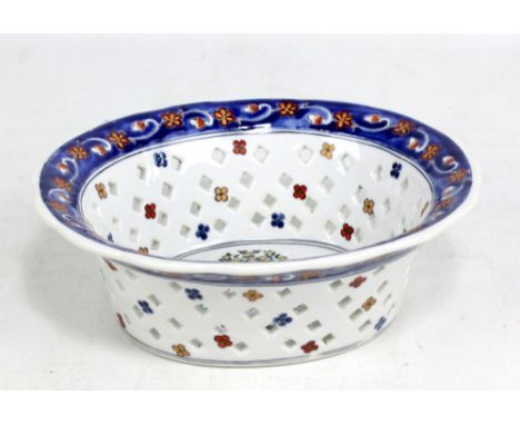 An early to mid-20th century Chinese porcelain oval chestnut basket produced for the European market, the central panel paint