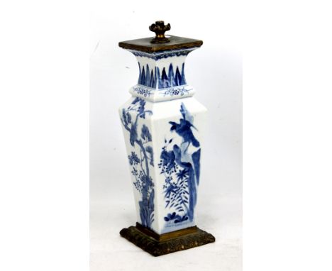 A 19th century Chinese porcelain vase of tapered form painted in underglaze blue with birds amongst branches beneath plantain