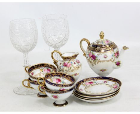 NORITAKE; a cream ground floral decorated gilt heightened four piece tea set comprising teapot, jug, height 12cm and four cup