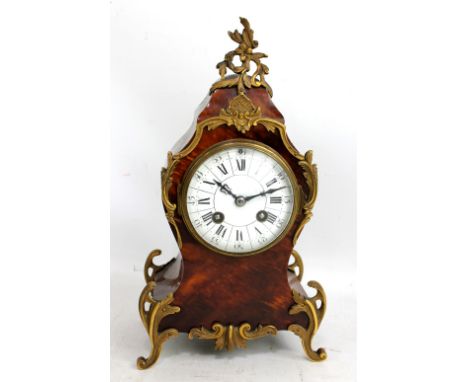 A late 19th century French tortoiseshell and gilt metal mounted mantel clock, the white enamel dial set with Roman and Arabic
