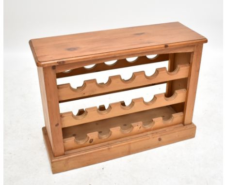 A pine three shelf wine rack to hold fifteen bottles, width 82cm.