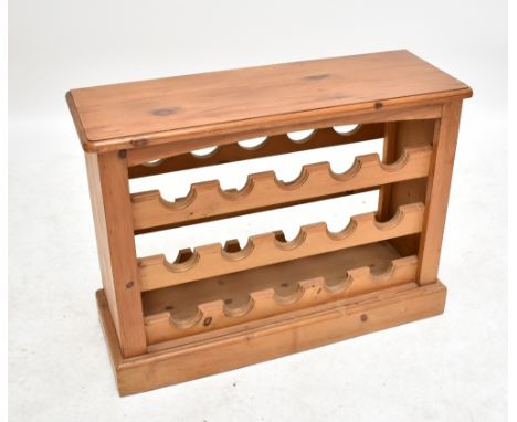 A pine three shelf wine rack to hold fifteen bottles, width 82cm.