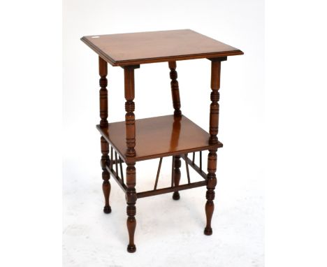 An Edwardian walnut two tier square occasional table on ring turned supports.