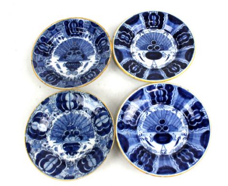 A pair of 18th century Dutch Delft 'Peacock' plates, de Klaew Factory, with ochre tinted rims, one marked, diameter 23cm, and