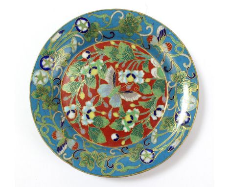 A 19th century Chinese cloisonné enamel red and blue ground dish, decorated with butterflies amongst stylised flowers and vin