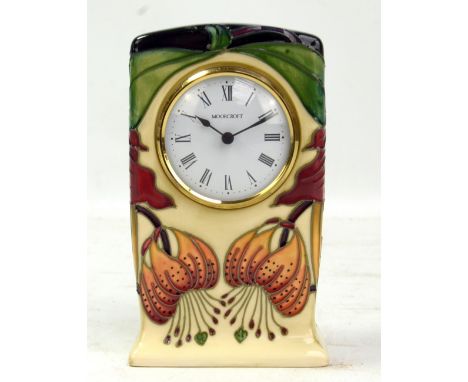 MOORCROFT; an 'Anna Lily' pattern tubeline decorated clock with impressed marks and year cipher for 2010 to base, height 16cm