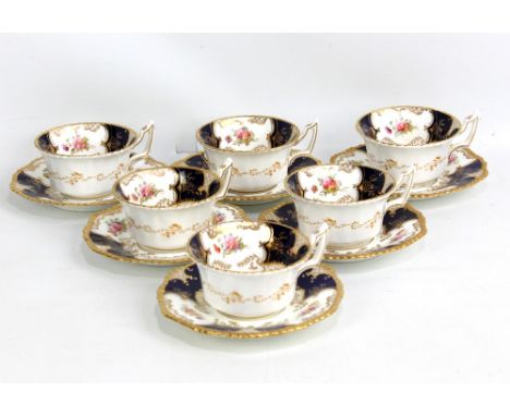 COALPORT; a set of six late 19th/early 20th century 'Blue Batwing' pattern tea cups and saucers with gilt and floral decorati