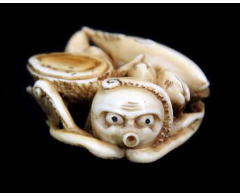 A 19th century Japanese carved ivory netsuke of a group of fish, shells and octopus, 4 x 3.7cm.Additional InformationLight na