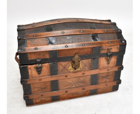 A twin handled studded and slatted leather travelling trunk with domed hinged lid, width 78cm.