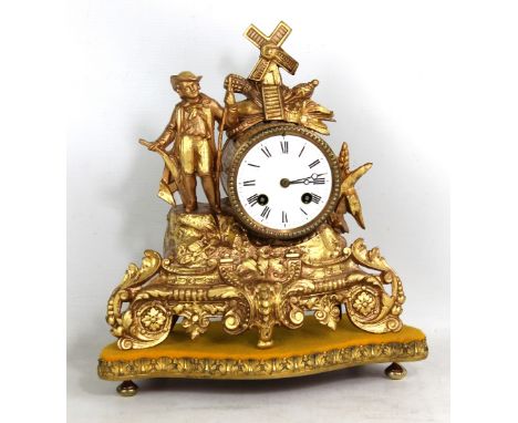 A late 19th century French spelter eight day figural mantel clock, the white enamel dial set with Roman numerals, the movemen