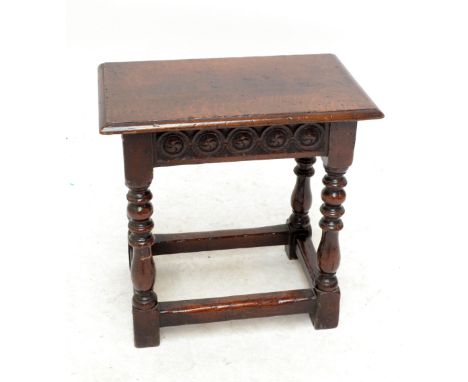 An oak joint stool with carved detail on ring turned legs to block feet.&nbsp;