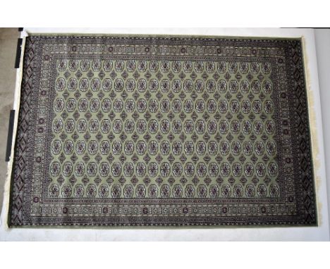 A green ground Bokhara carpet, 300 x 200cm.