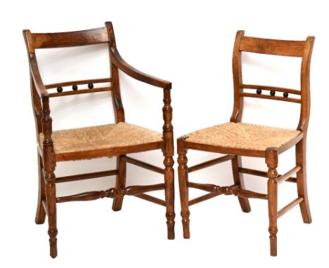 A set of six early to mid 19th century North Country ash and elm dining chairs with rush seats above ring turned front suppor