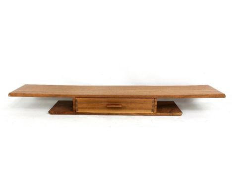 IAN TAYLOR; a walnut and pear wood wall shelf with drawer, width 89.5cm.