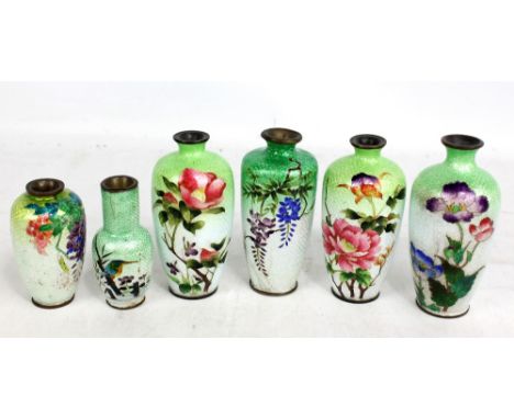 A Japanese Meiji period suite of three gimbari cloisonné enamel vases decorated with floral motifs, the tallest 13cm, and thr