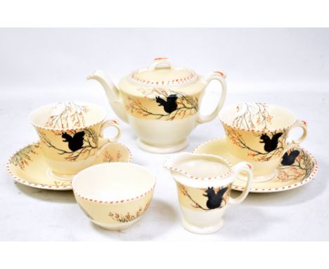 BURLEIGH WARE; an Art Deco 'Tudor'&nbsp;shape tete-a-tete tea set, each piece decorated with a silhouette of a squirrel on a 