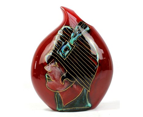 ANITA HARRIS; a drop shaped vase on dark red ground decorated with a gilt heightened image of a flapper, monogram and printed