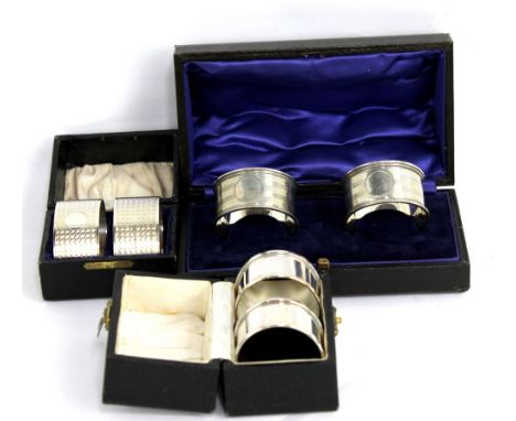 Three pairs of hallmarked silver napkin rings to include an oval engine turned decorated example by FB Bros, Birmingham 1925,