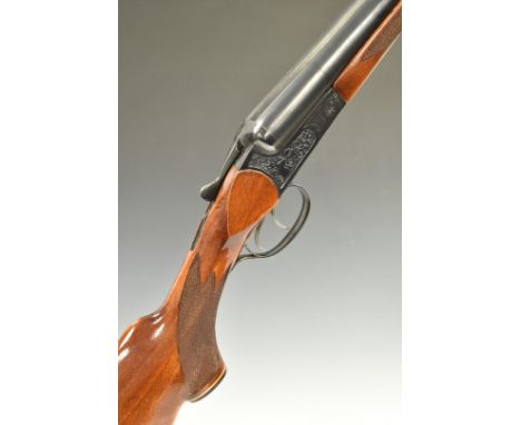 Baikal IJ-58 12 bore side by side ejector shotgun with heavy engraving of stag heads to the locks, chequered semi-pistol grip