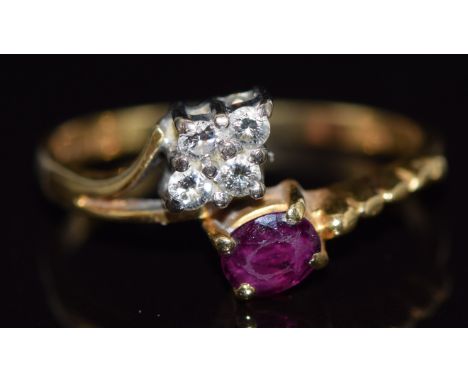 An 18ct gold ring set with an oval cut ruby and four diamonds, 2.9g, size N