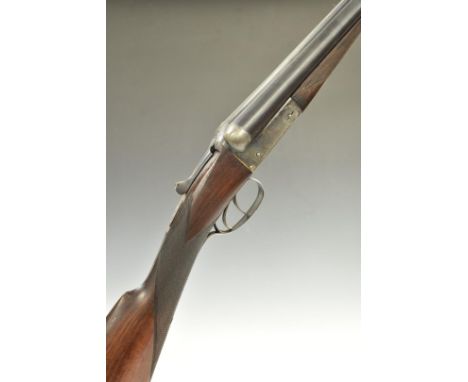 Two 12 bore side by side shotguns, each with engraved locks, trigger guard, underside and thumb lever and chequered grip and 