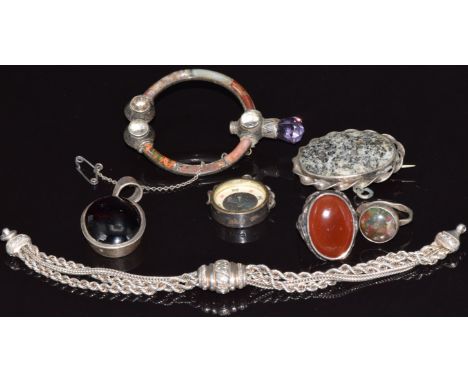 A Scottish agate silver brooch, silver ring, silver pendant set with a garnet cabochon, silver compass charm (Chester 1926), 